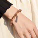 Golden Bone Crystal Bracelet with Tassel Design